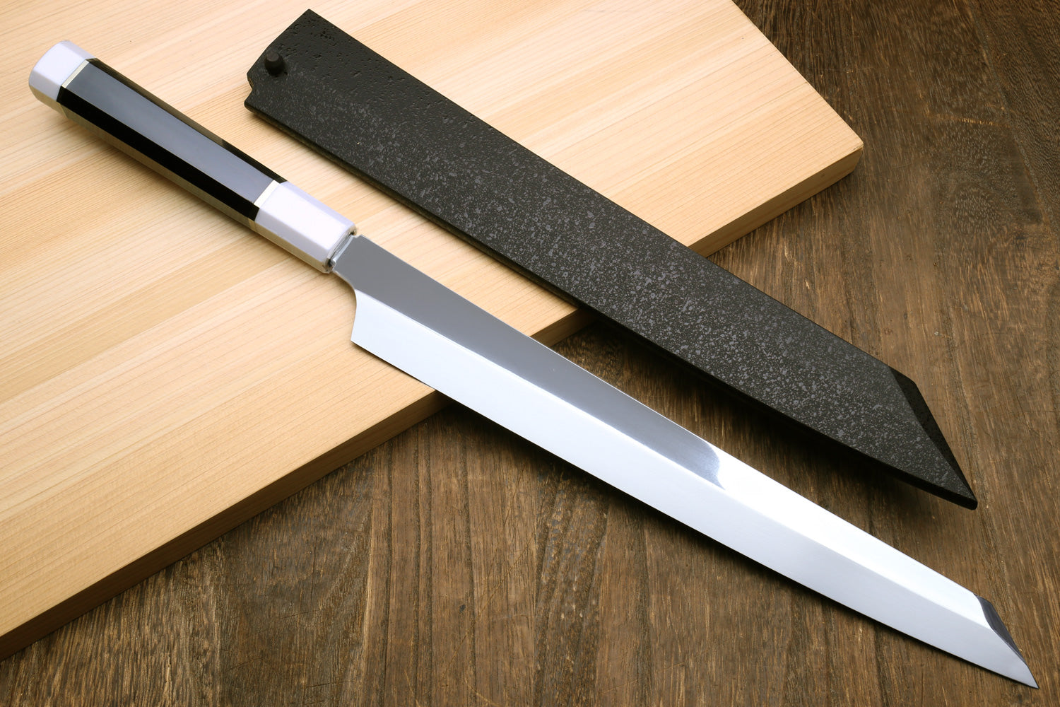Japanese sushi knife pair on boards, polished steel blades with dark ebony handles