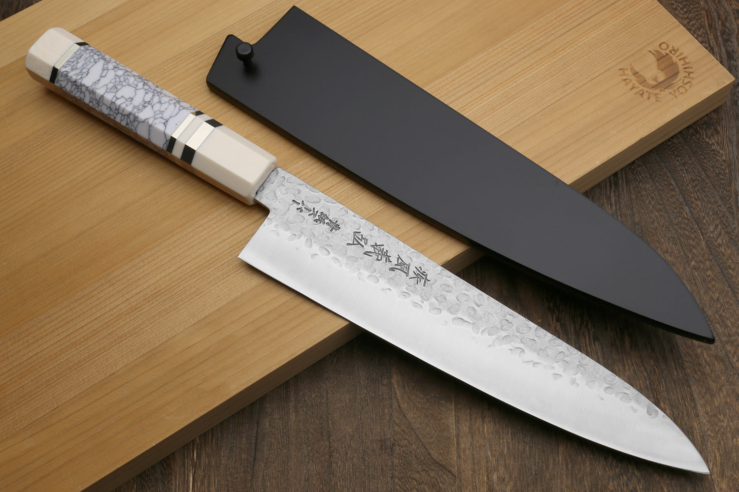 Chef's gyuto knife with hammered stainless blade and white-gray crackle handle