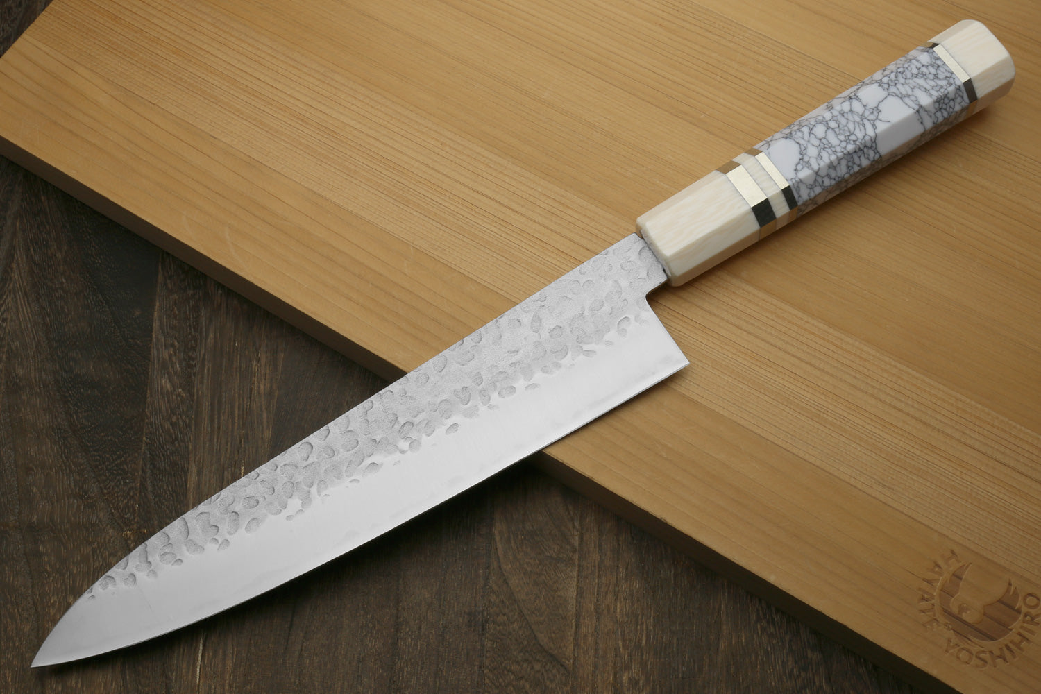 Chef's gyuto knife with white-gray crackle handle scales and hammered blade