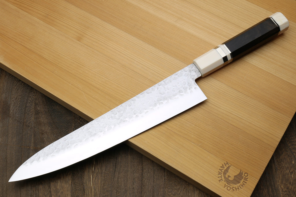 Gyuto chef knife with hammered stainless blade and black ebony handle, ivory bolster