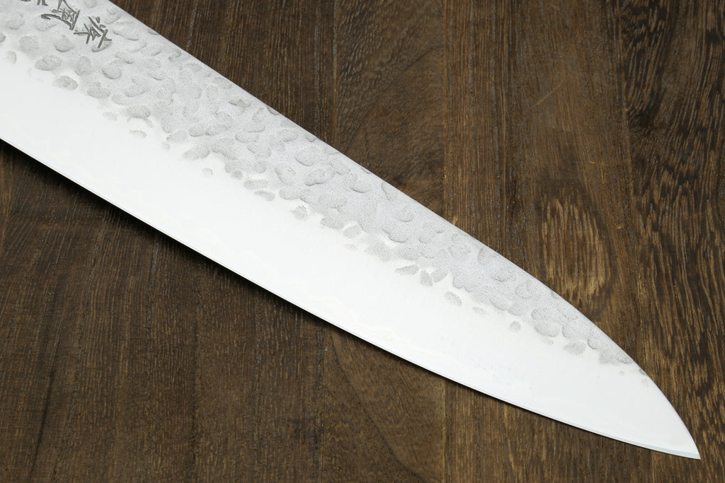 Hammered stainless gyuto blade with pointed tip, showing etched patterns