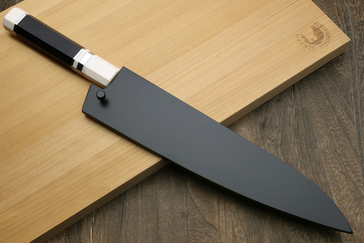 Hammered gyuto chef's knife in black sheath, ebony handle with ivory bolster