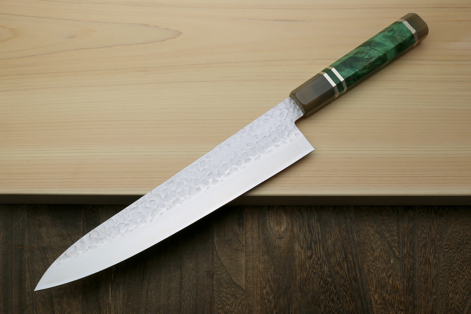 Gyuto chef knife with white hammered blade, green-stone handle, and metal ferrules