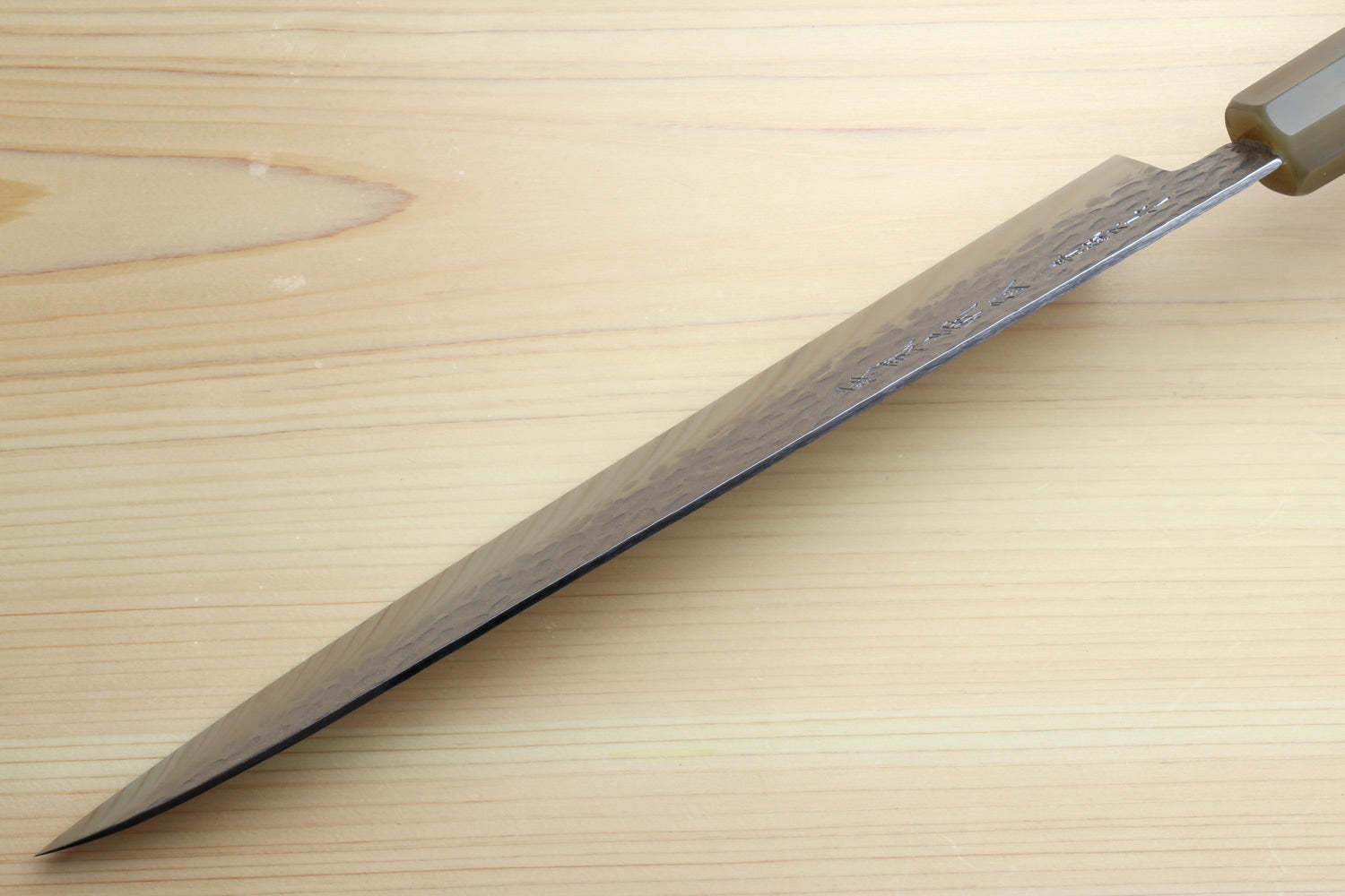 Gyuto chef knife side view with dark edge and green stabilised handle