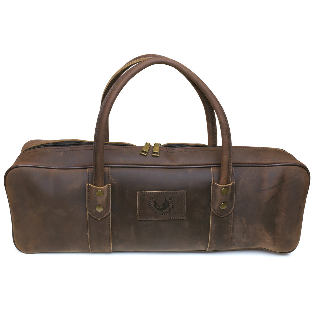 Brown leather knife bag front view with emblem patch and two button strap tabs