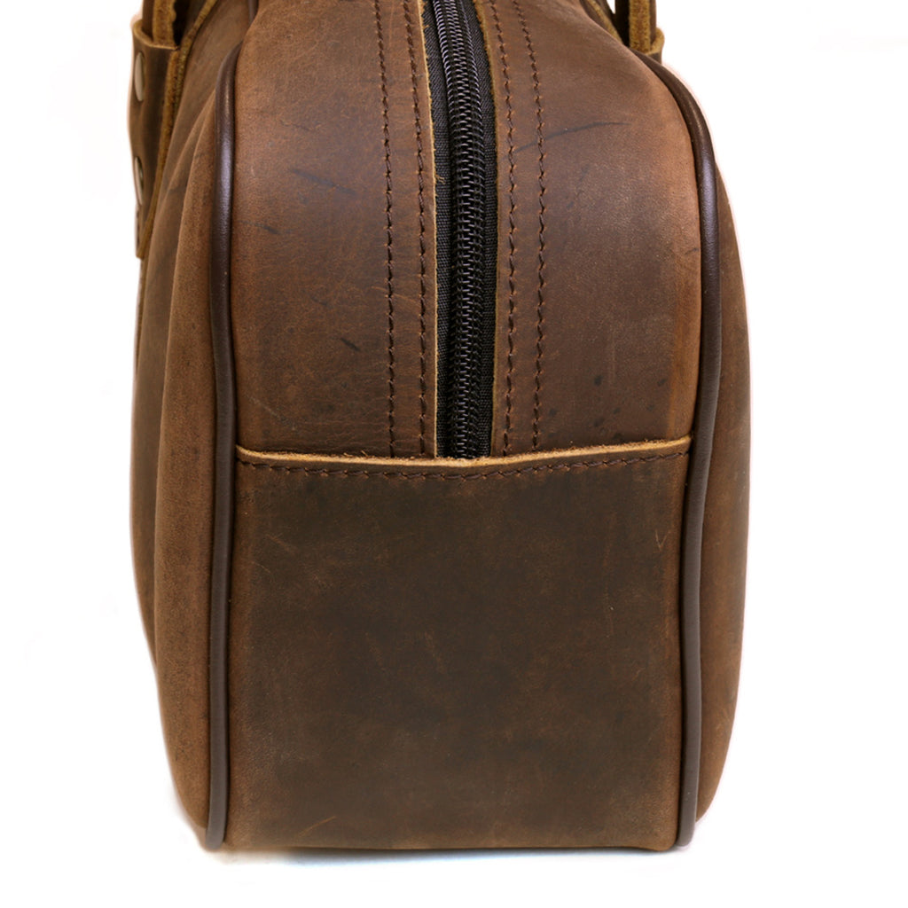 Brown leather knife bag end view with vertical zipper and stitched seams
