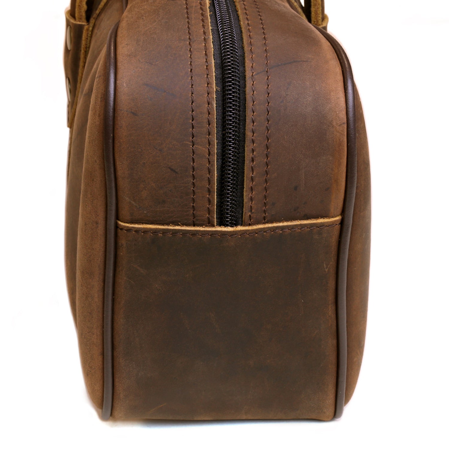 Brown leather knife bag end view with vertical zipper and stitched seams