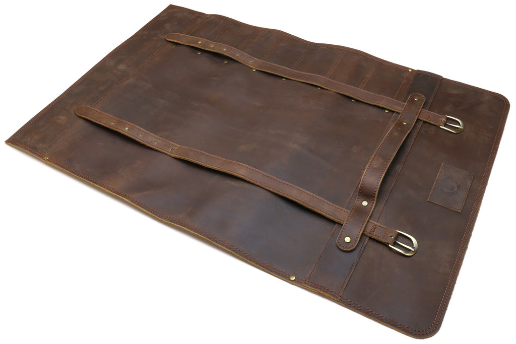 Brown leather knife roll case laid flat with front strap, buckle, and interior divider.