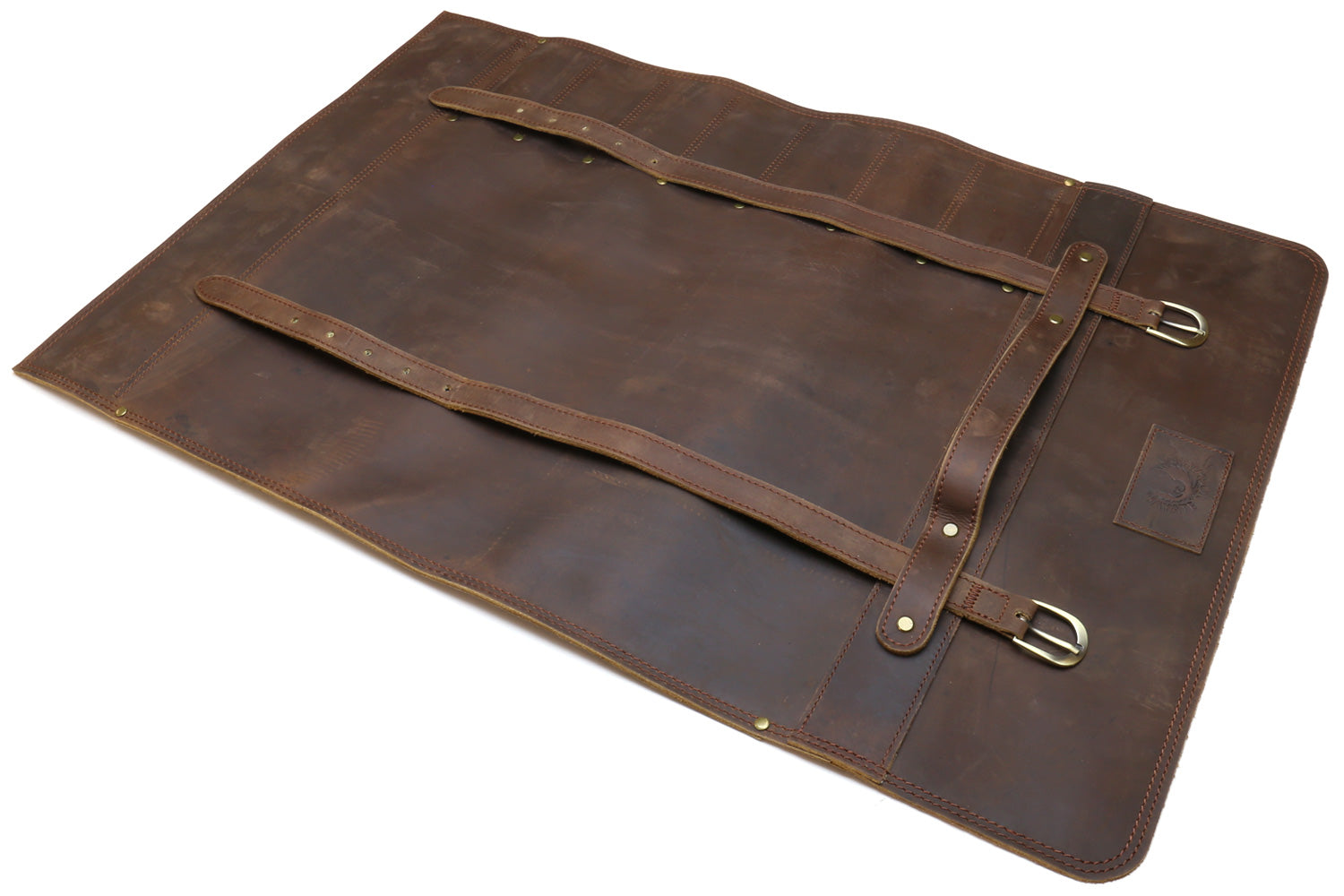 Brown leather knife roll case laid flat with front strap, buckle, and interior divider.