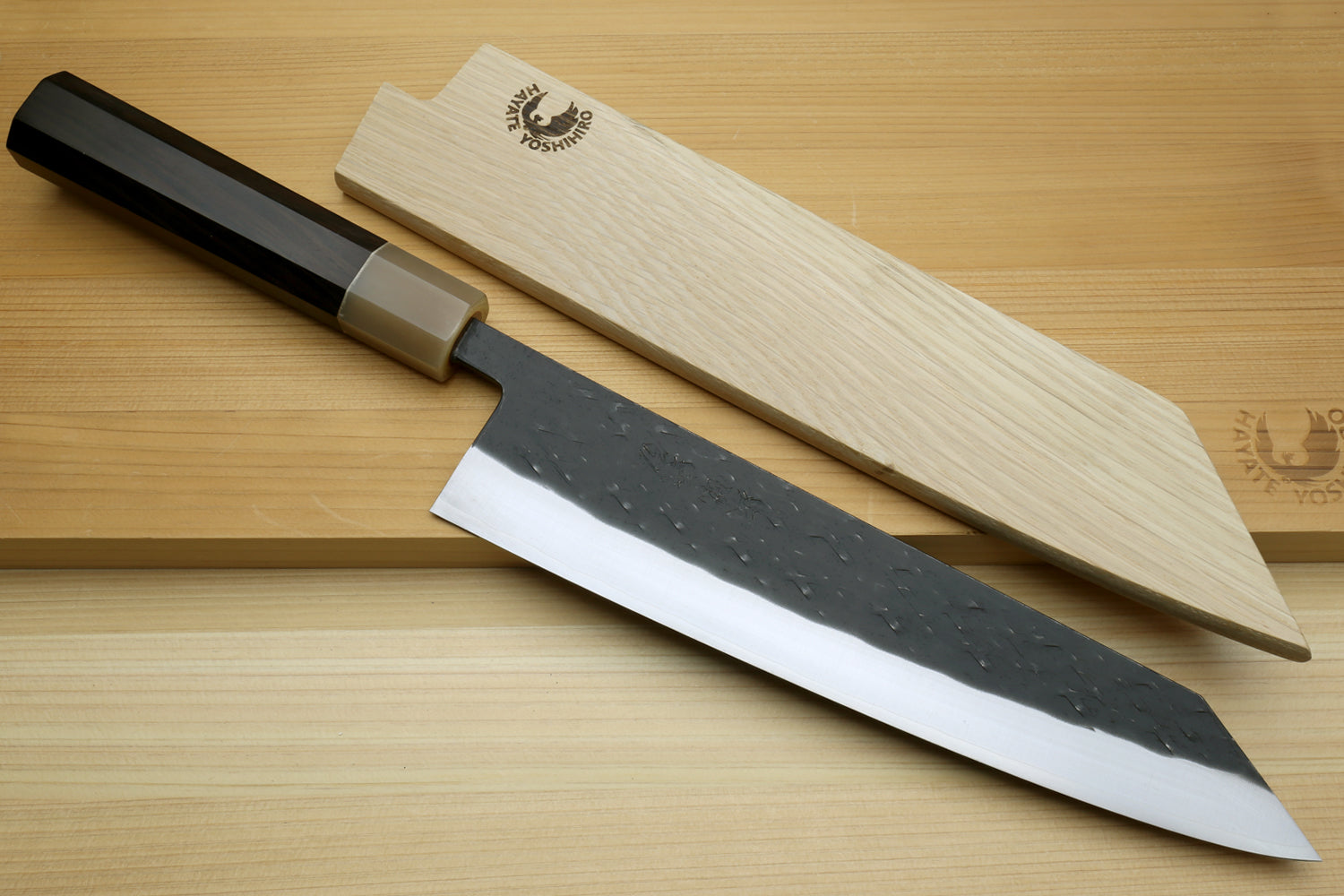 Kiritsuke chef knife with wooden saya cover, dark handle and hammered black blade