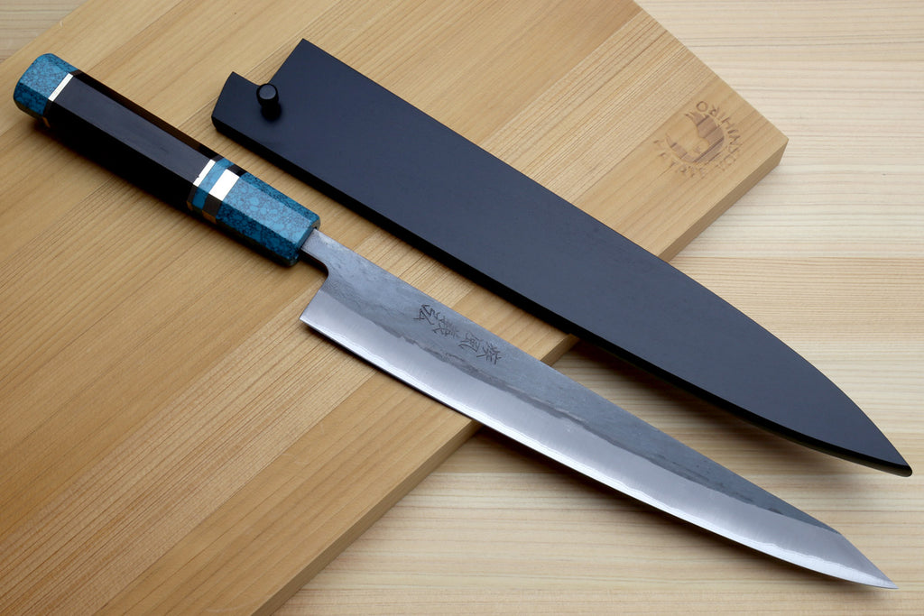 Sujihiki knife with turquoise handle, dark cover, and exposed polished blade
