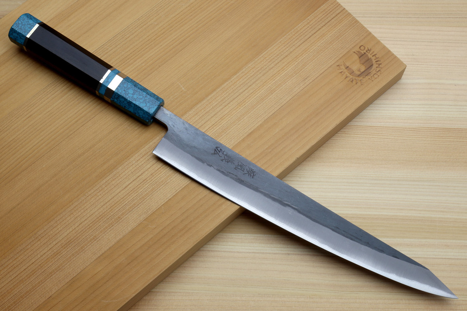 Turquoise-handled sujihiki knife with polished pointed blade