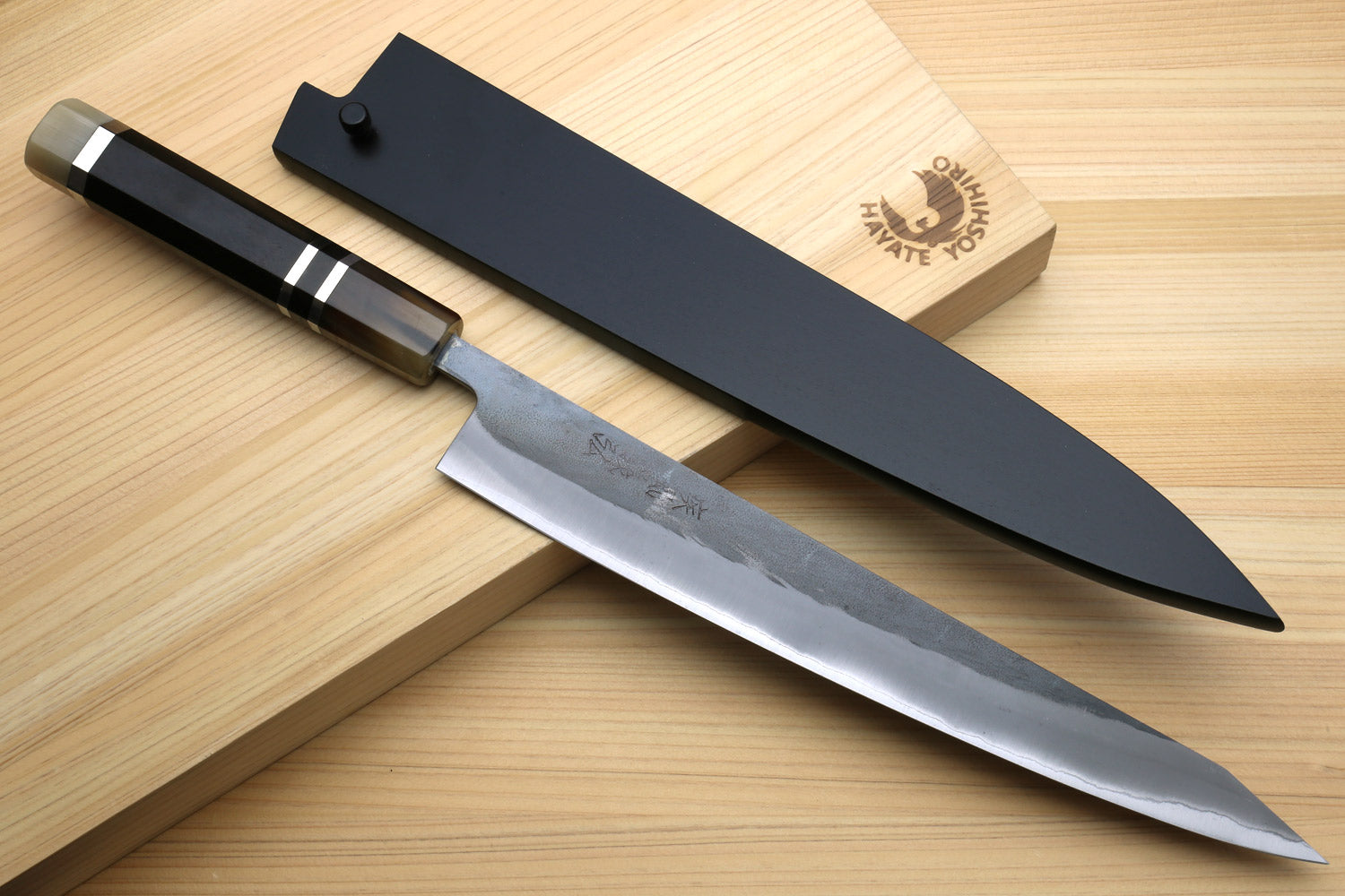 Kiritsuke slicer knife with black saya cover and pointed silver blade