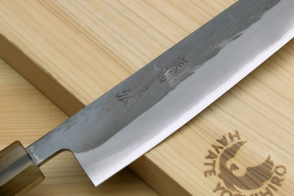 Kiritsuke slicer knife blade close-up with etched pattern and sharpened edge