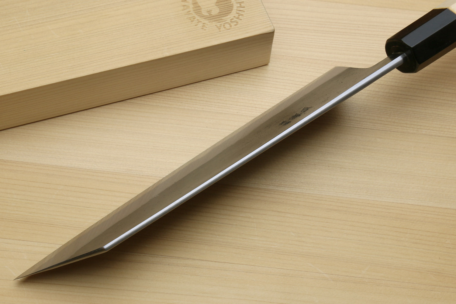 Kiritsuke chef knife with long dark blade and black handle