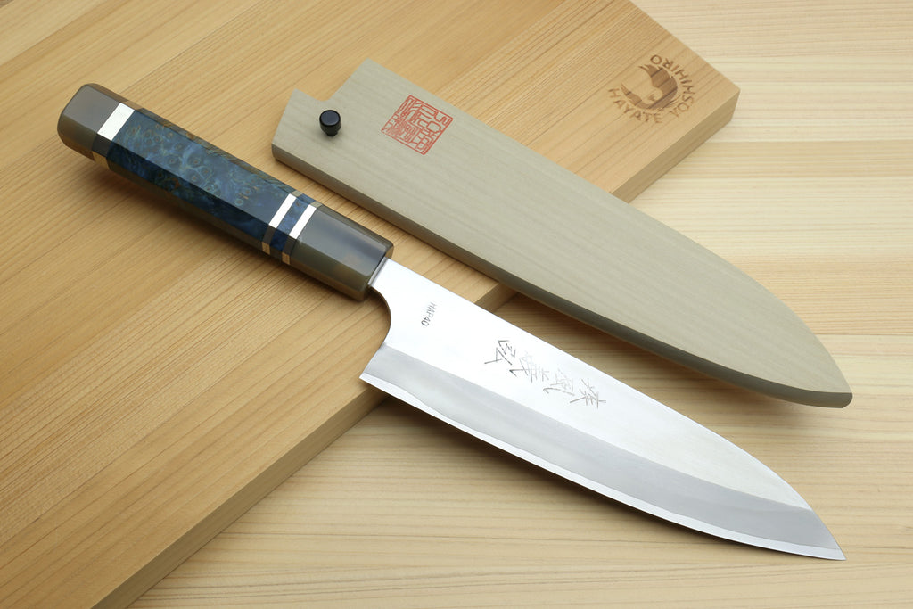 HAP40 petty chef knife with ocean blue handle, shown on light wooden boards