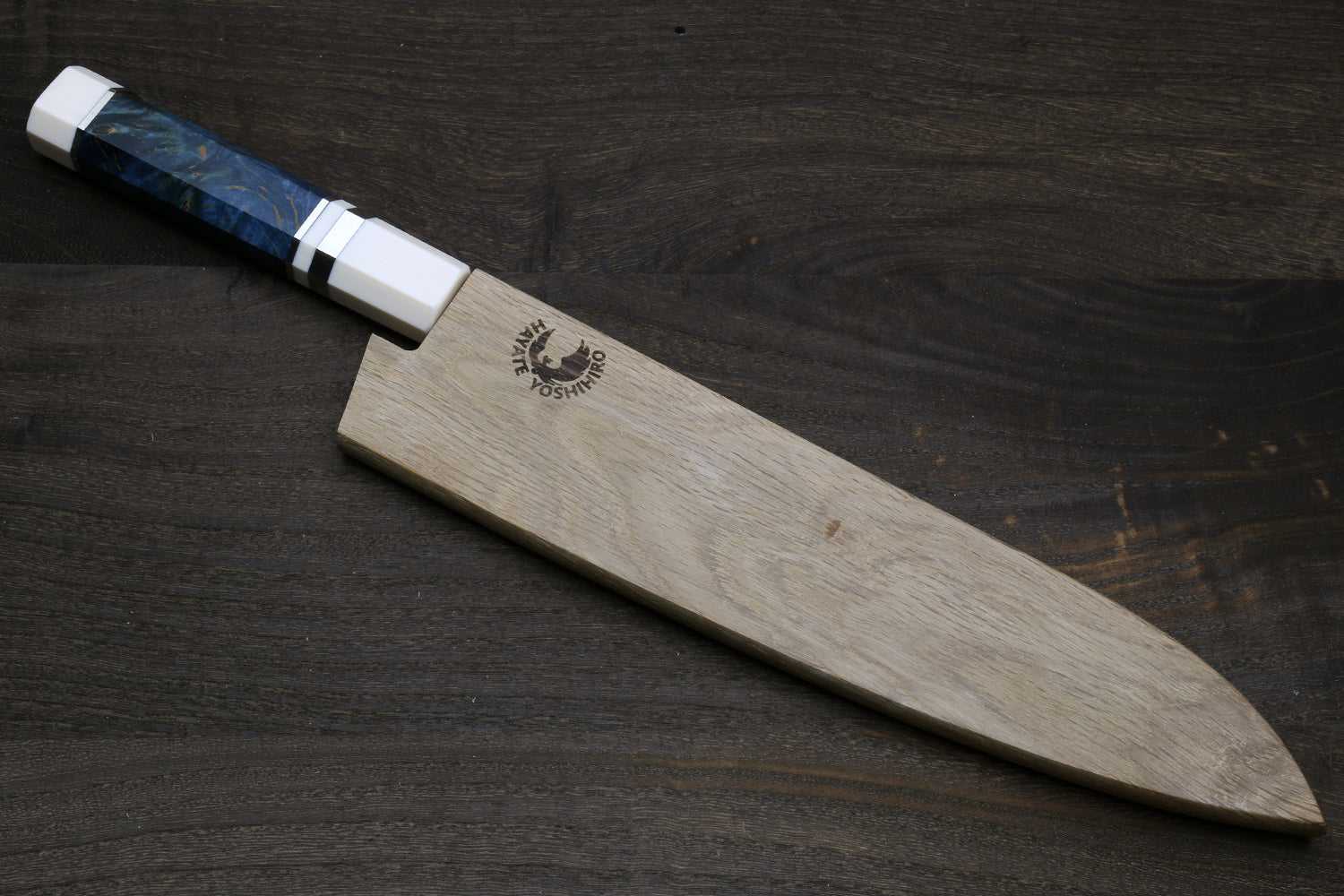 Gyuto chef knife with ocean blue handle, ivory bolster, and stamped stainless blade