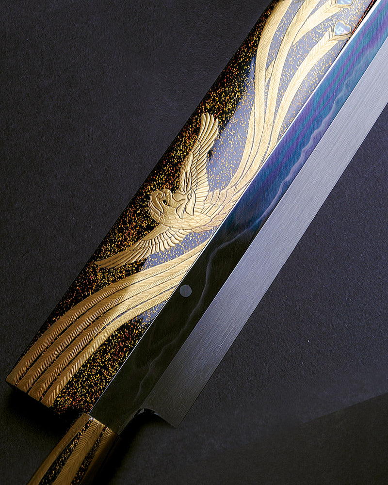 Decorative knife with gold and blue handle on a dark background