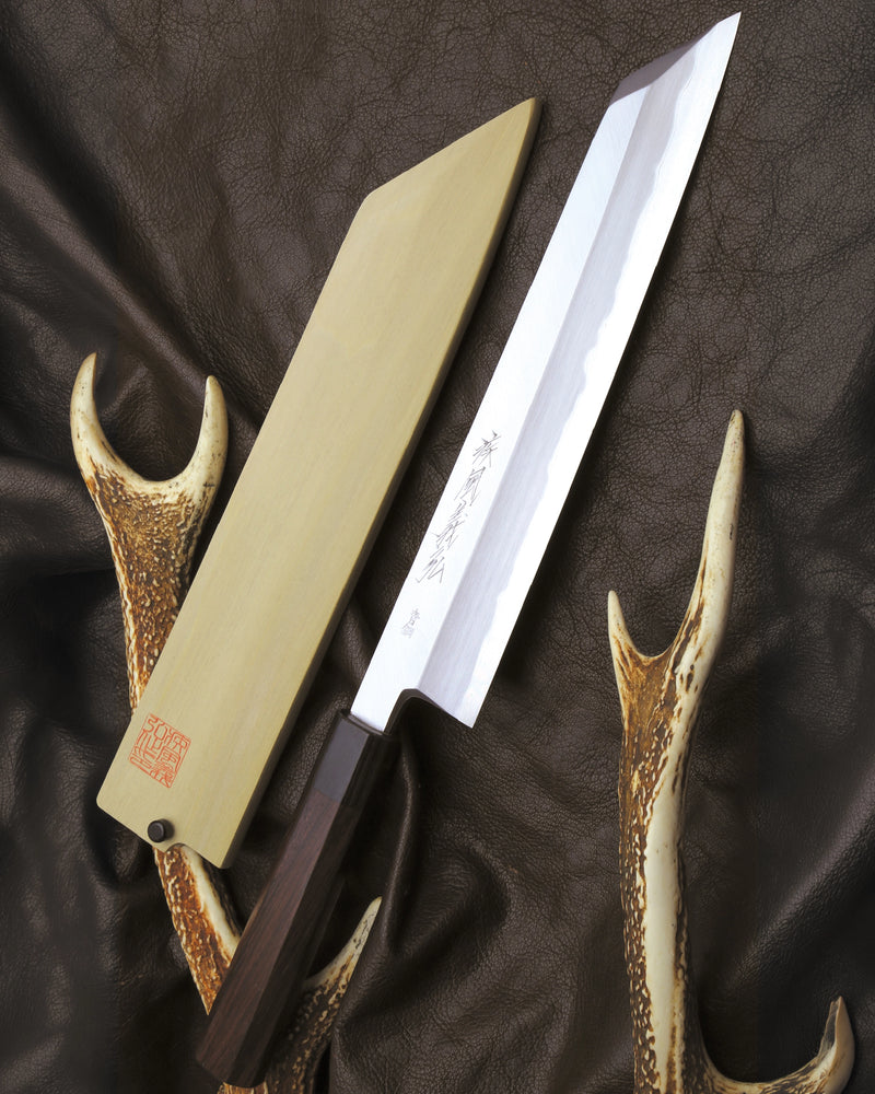 Knife with with a cover on a dark fabric background
