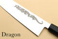 Dragon engraving on white card with black edge tool at corner