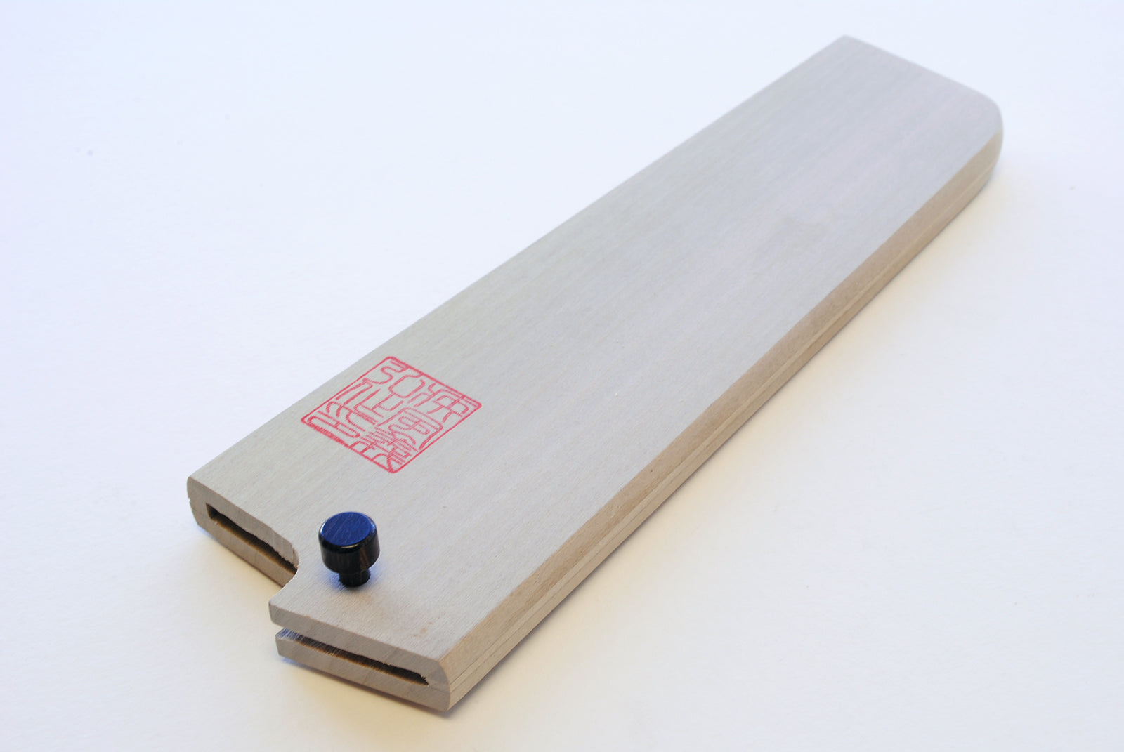 Magnolia wood nakiri blade protector with red stamp and two blue mounting bumps