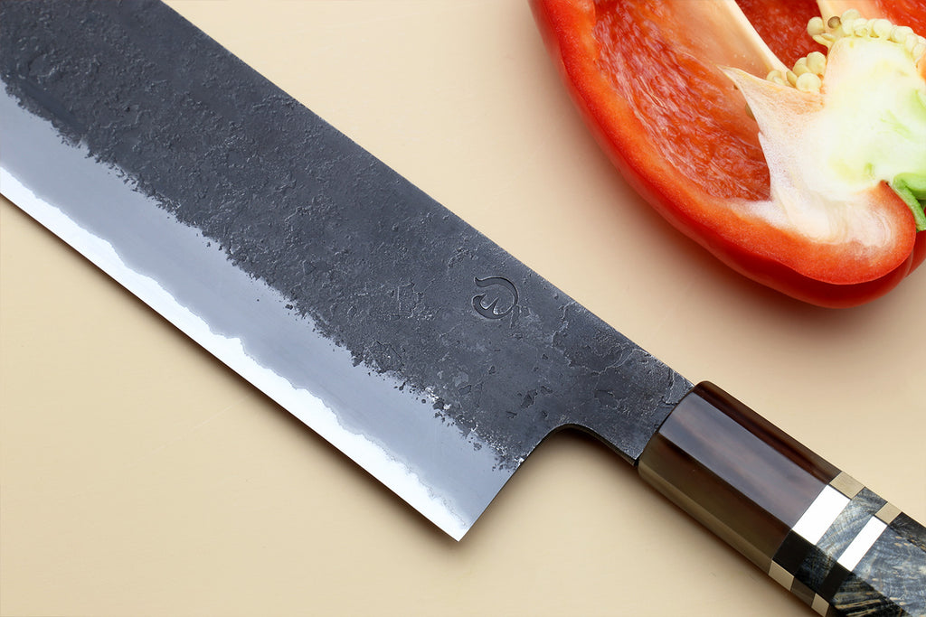 Nakiri vegetable knife with dark blue forged blade and dark handle, stainless clad edge