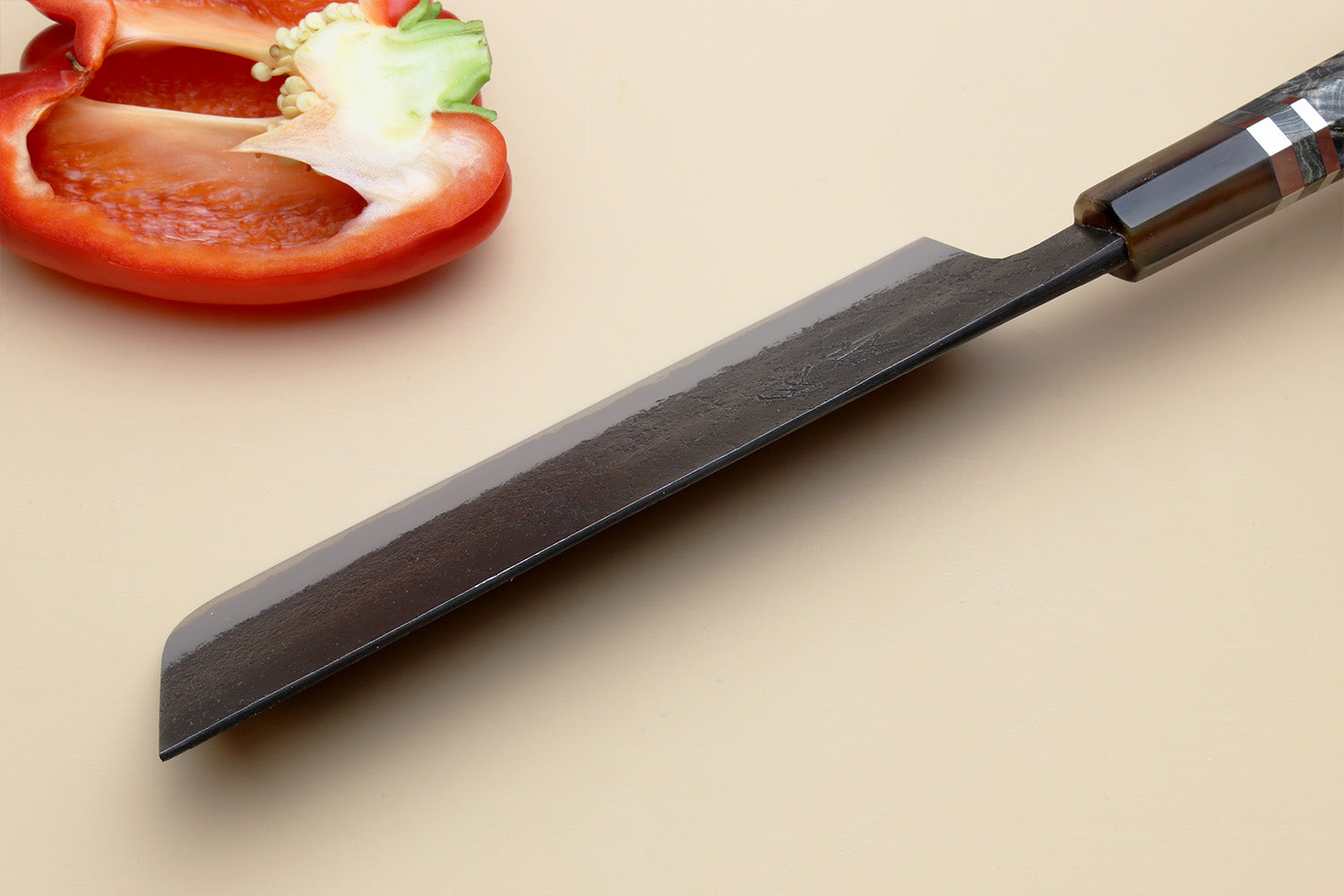 Nakiri vegetable knife angled view with dark forged blade and straight tip