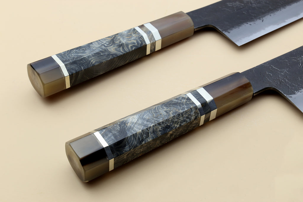 Nakiri vegetable knife with blue-gray Damascus-style handle and dark forged blade