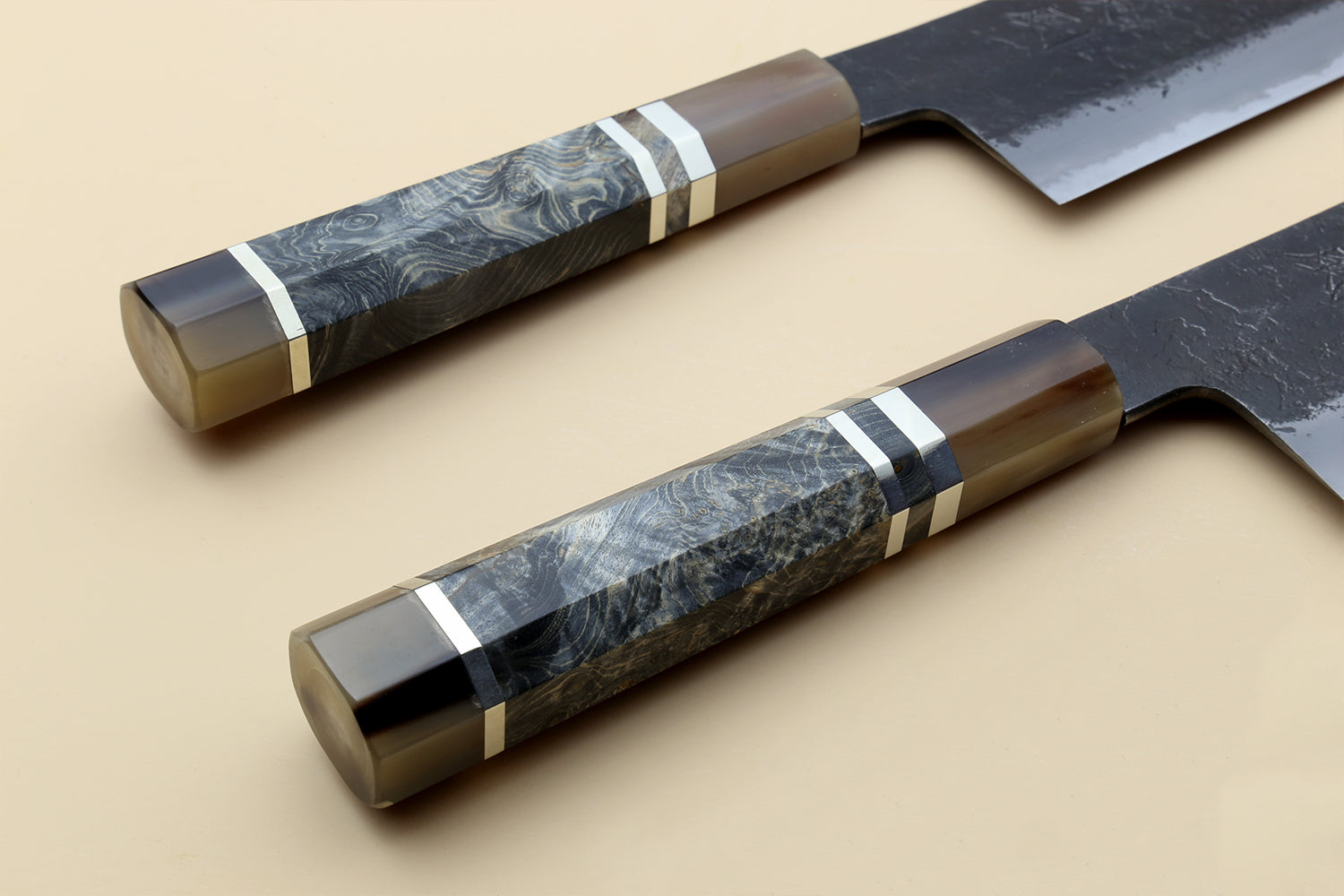 Nakiri vegetable knife with blue-gray Damascus-style handle and dark forged blade