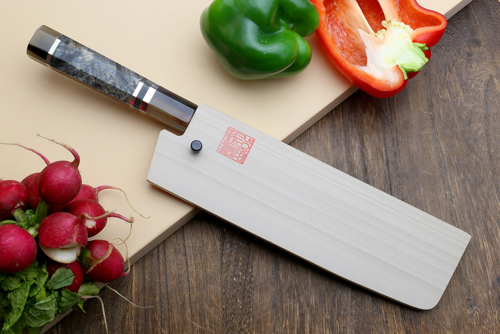 Nakiri vegetable knife with broad blade, stamped label on white handle plate, dark bolster