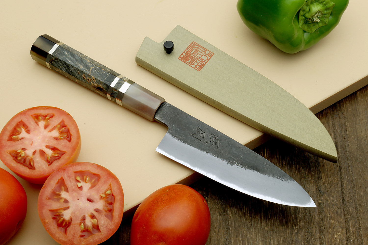 Paring knife with silver blade and dark wood handle, stamped blade logo visible.