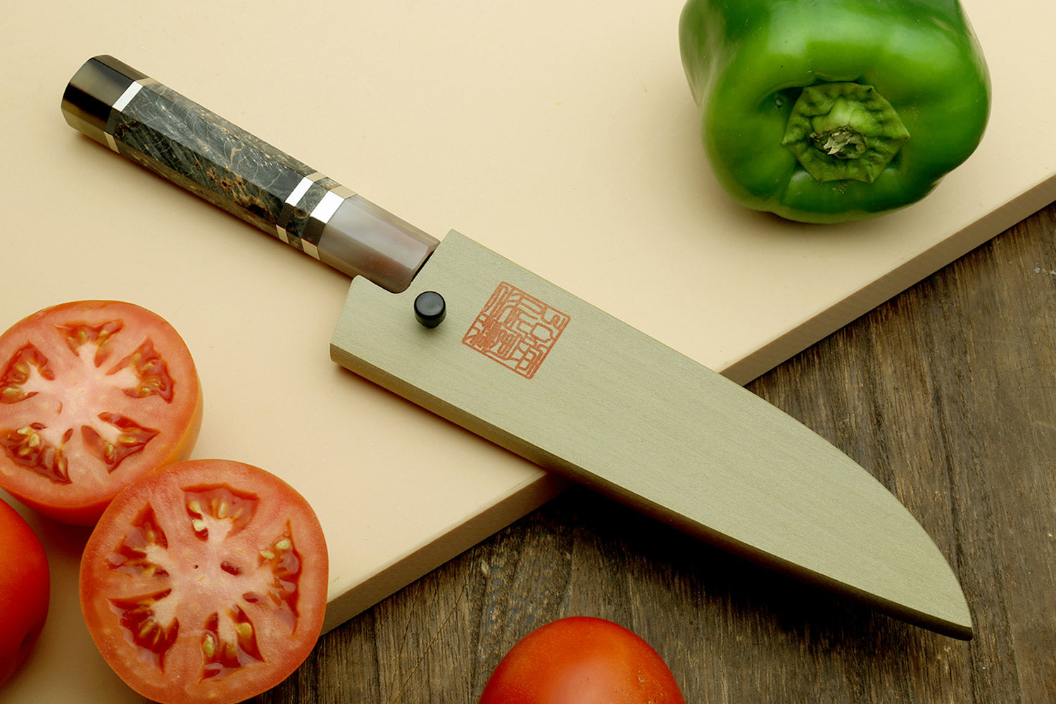Paring knife on cutting board with silver blade and dark wood handle.
