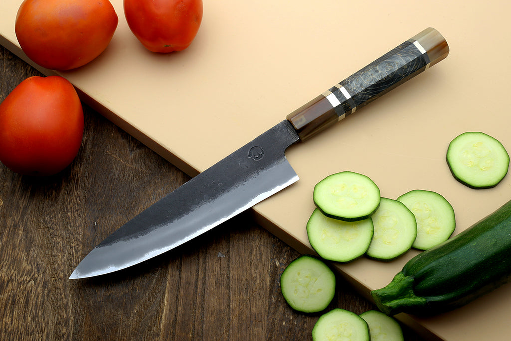 Petty utility knife with dark blade and patterned wood handle