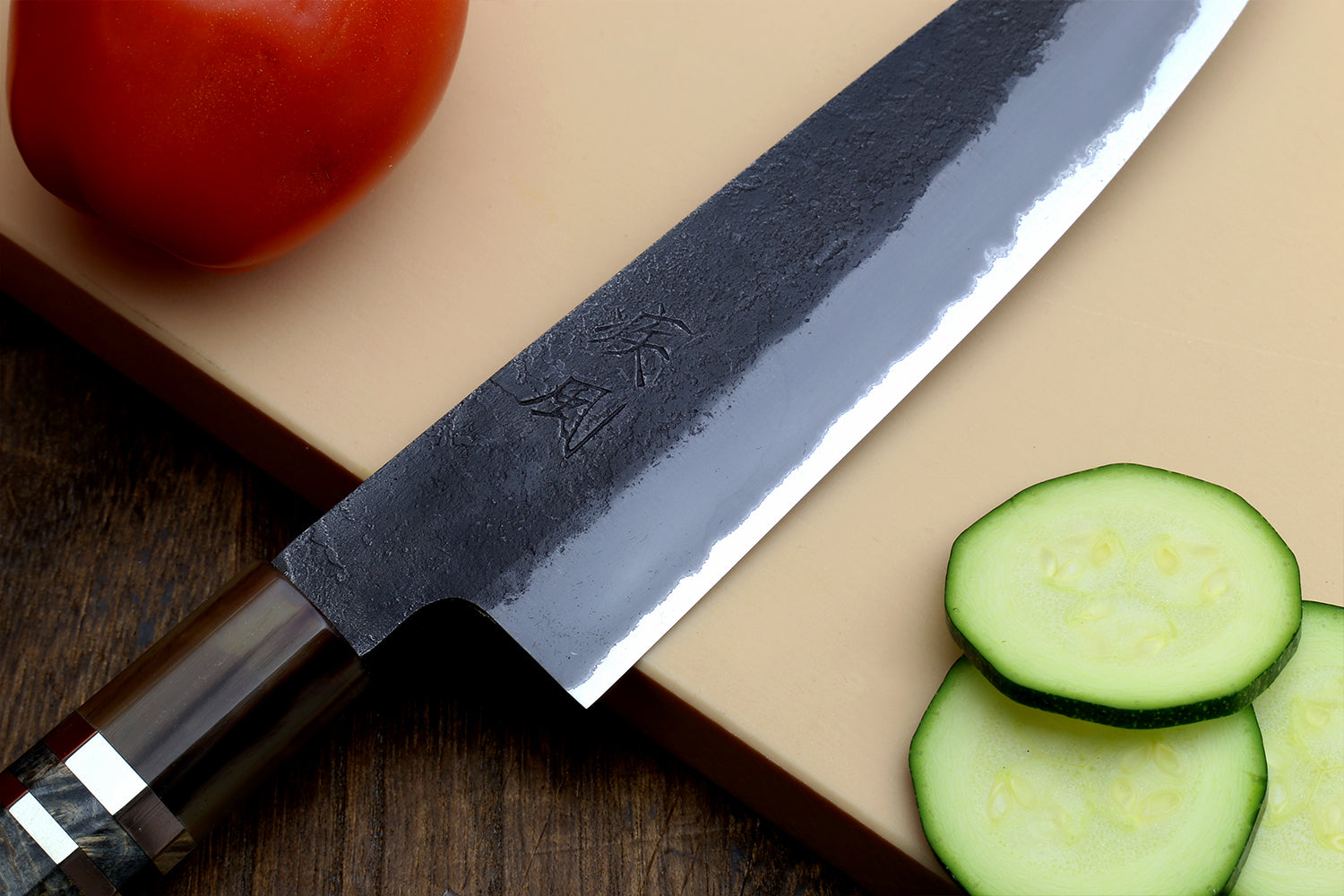 Petty utility knife blade close-up with stamped logo and wood handle