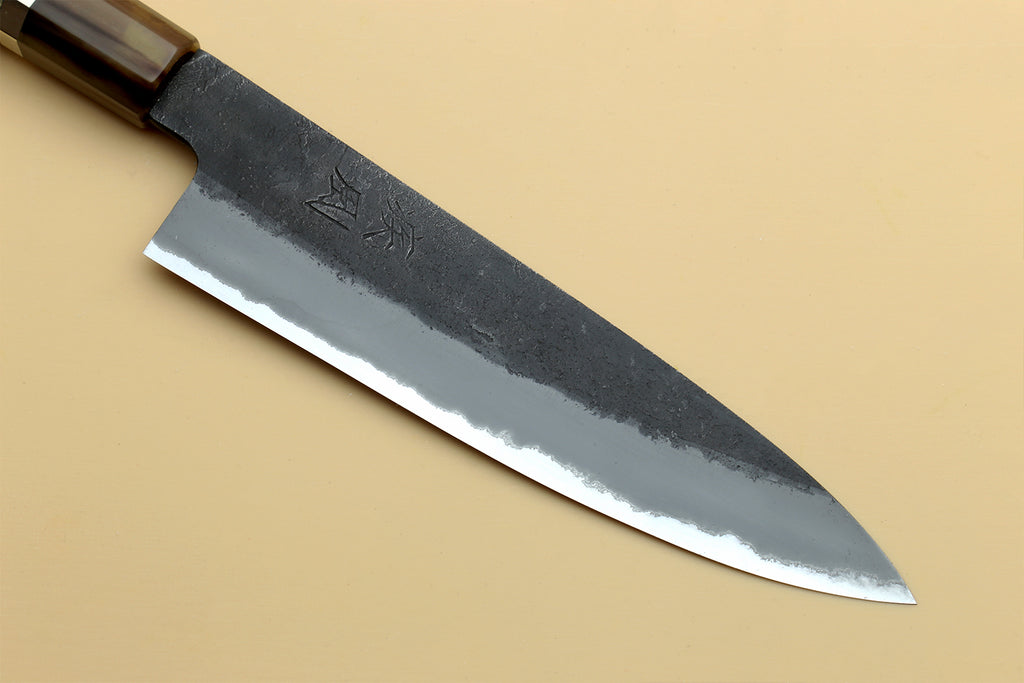 Blue steel petty knife blade with stamped marks and dark textured finish