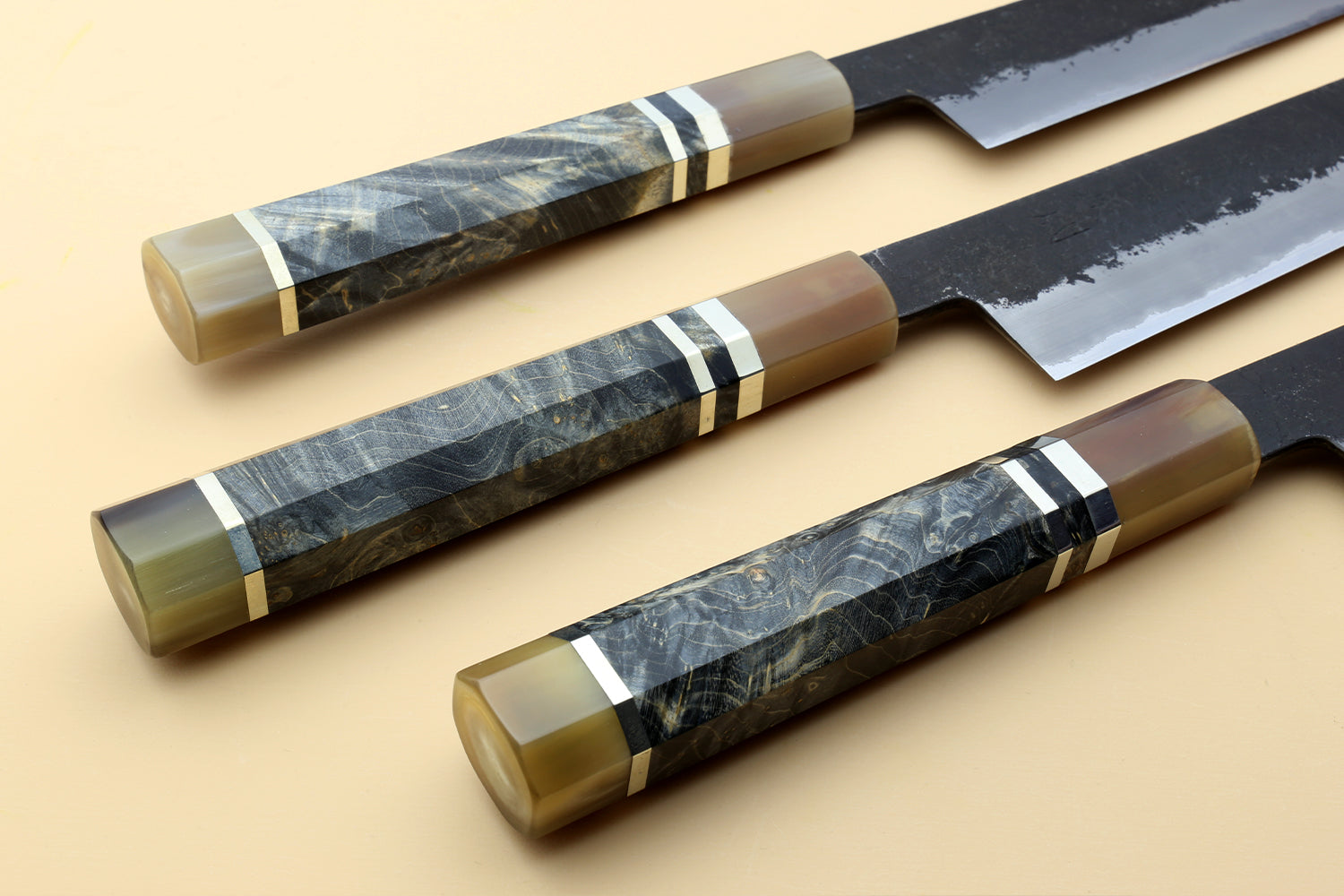 Sujihiki slicer knife with dark blue steel blade and wood-toned handle, blue accents