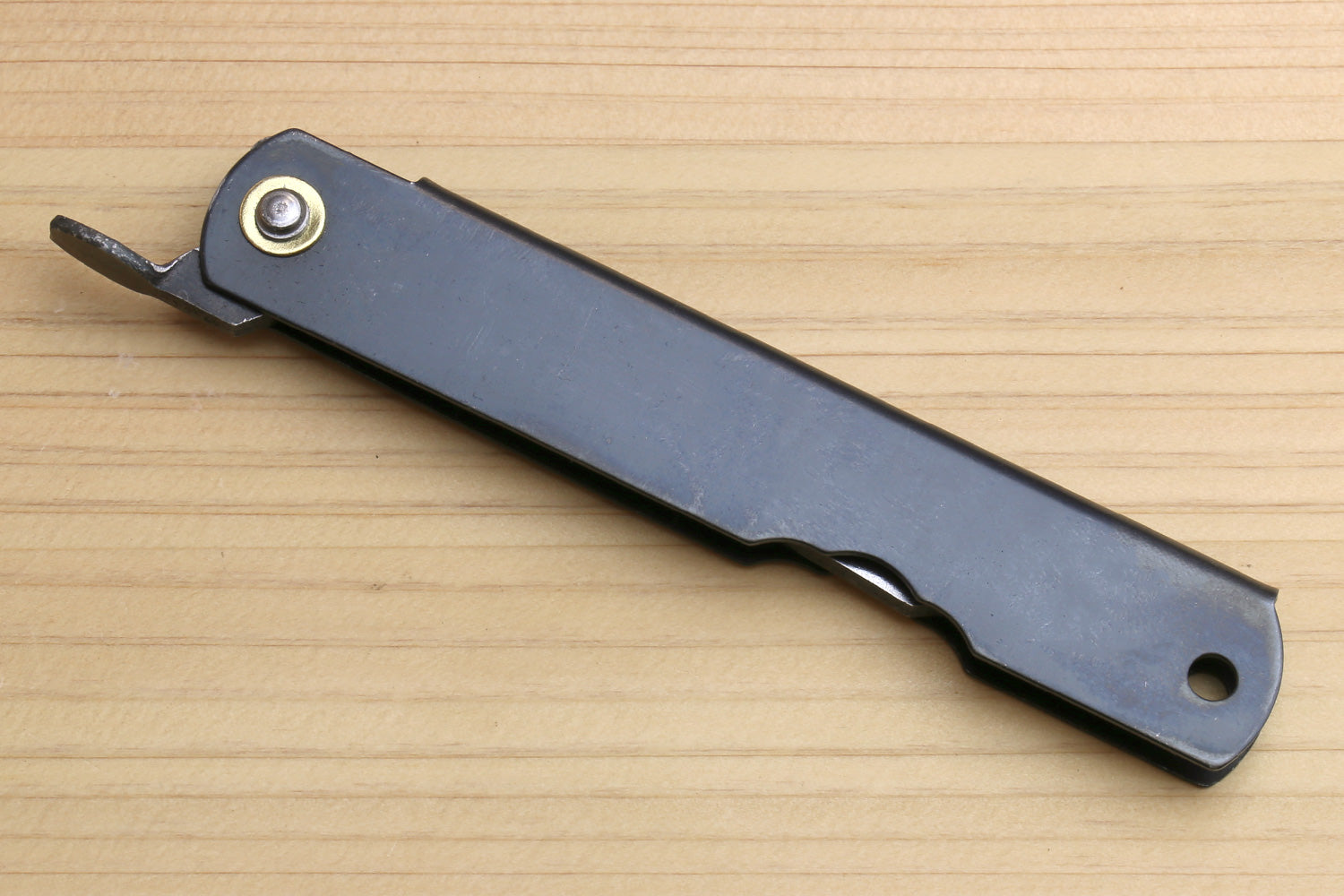 Pocket knife in dark sheath with two mounting holes and small protruding hook