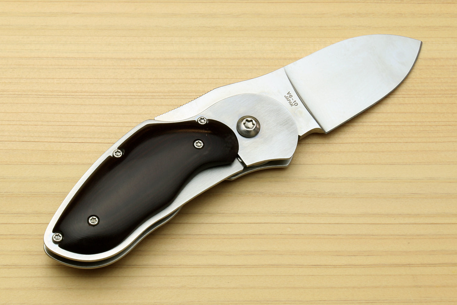 Stainless steel folding pocket knife with black handle, flipper, and polished blade