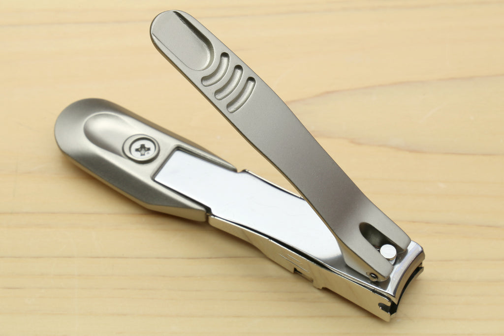 Magnetic nail clippers with silver curved handle and metal cutting head