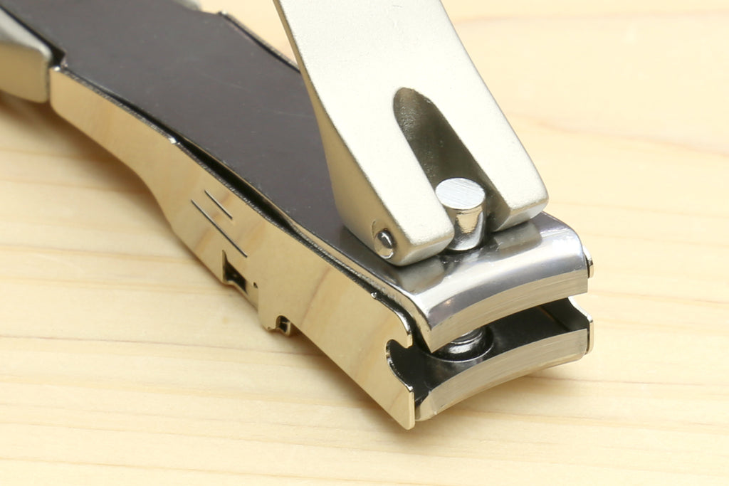 Magnetic nail clippers close-up of cutting head and silver-white guard
