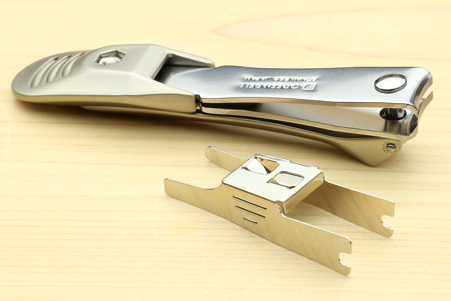 Magnetic nail clippers with engraved silver handle and included metal piece
