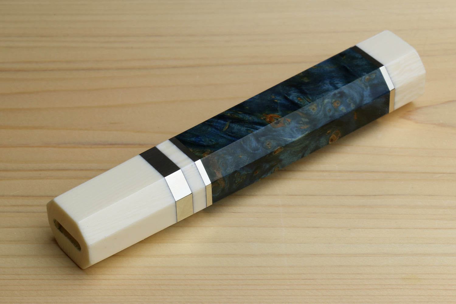 Ocean blue wrapped chef knife handle with ivory bolster and black spacer band, close view