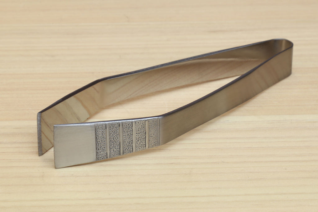 Non-slip fish bone tweezers, side view with textured center grip section.