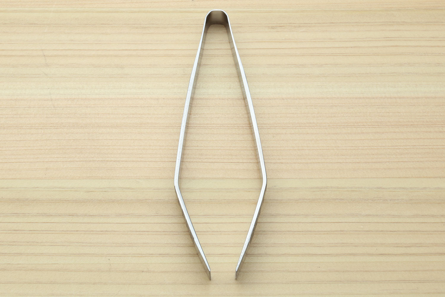 Non-slip fish bone tweezers, top view with pointed ends and smooth metal arms.