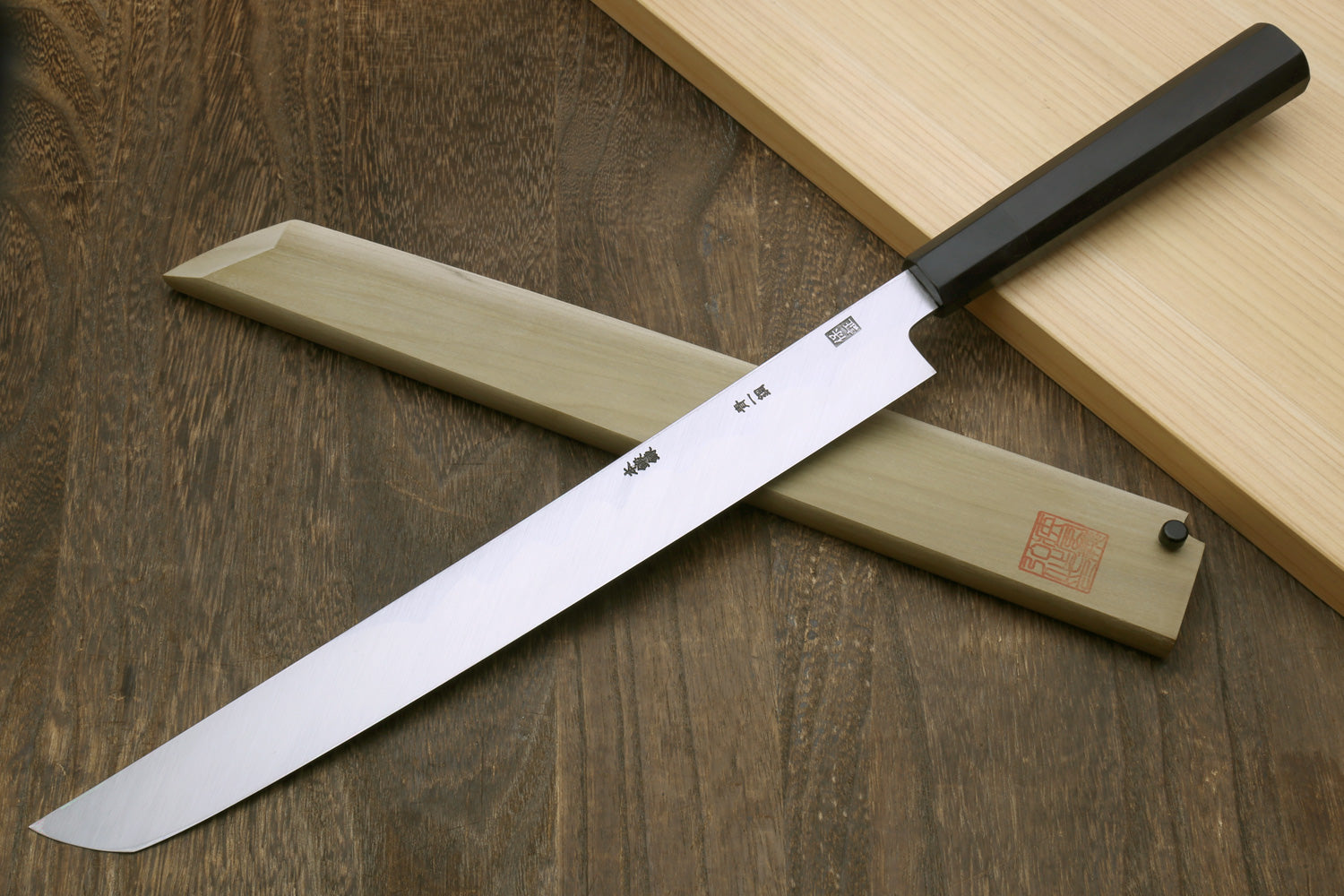 Sakimaru sushi knife with polished steel blade and ebony handle, etched near spine