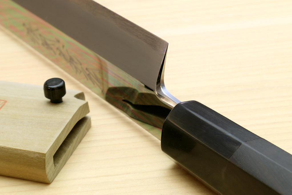 Sakimaru sushi knife side view with ebony handle and mirror-polished tip