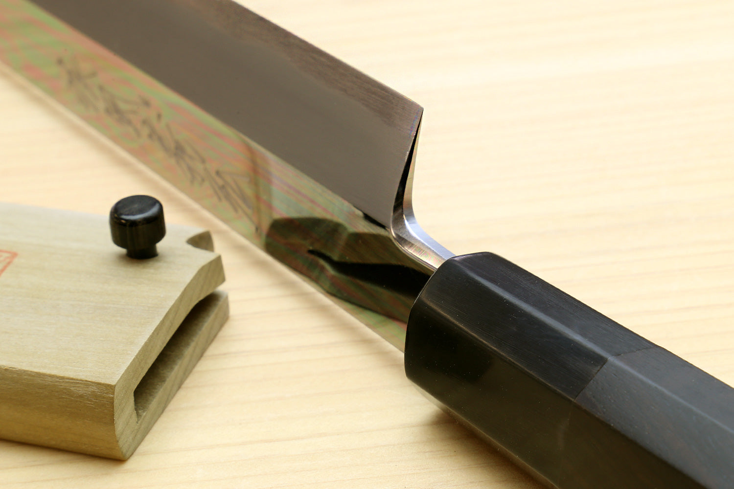 Sakimaru sushi knife side view with ebony handle and mirror-polished tip