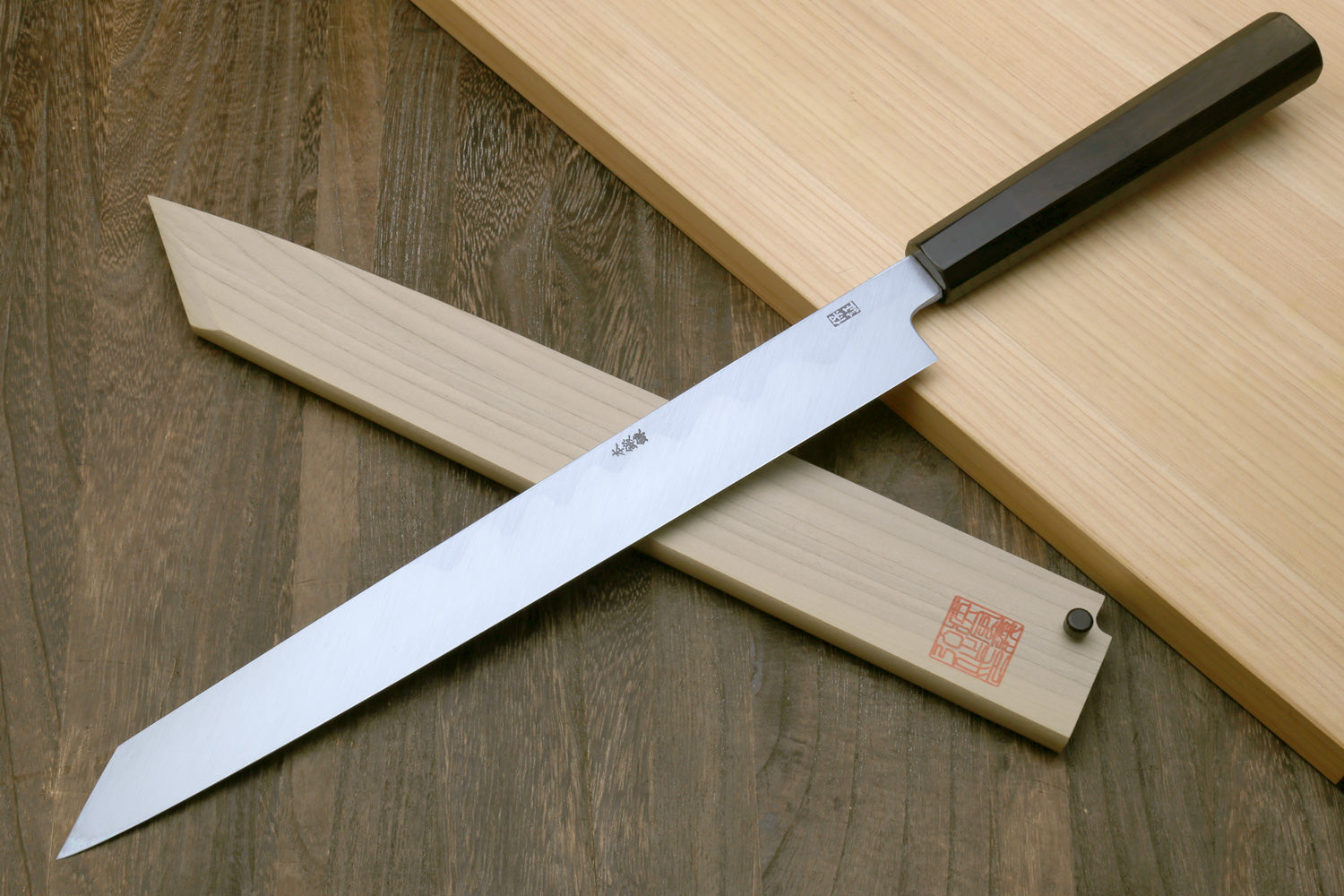 Japanese kiritsuke sushi knife with white blade and black ebony handle