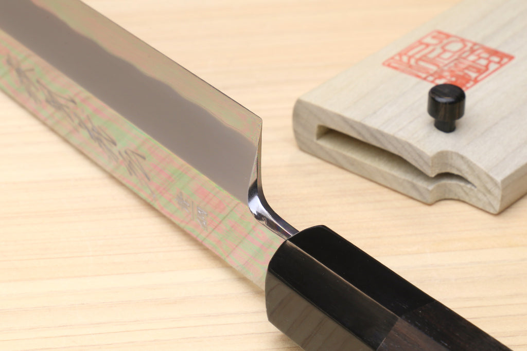 Japanese kiritsuke knife close-up, mirror-polished blade and black handle