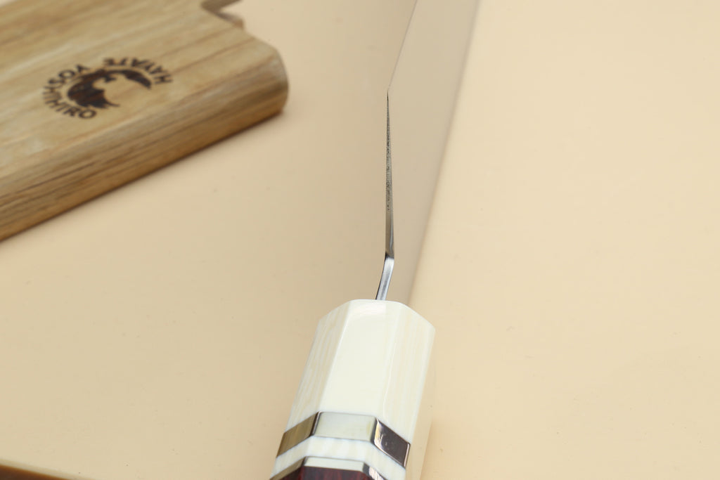 Chef knife bolster close-up with ivory grip and rosewood handle